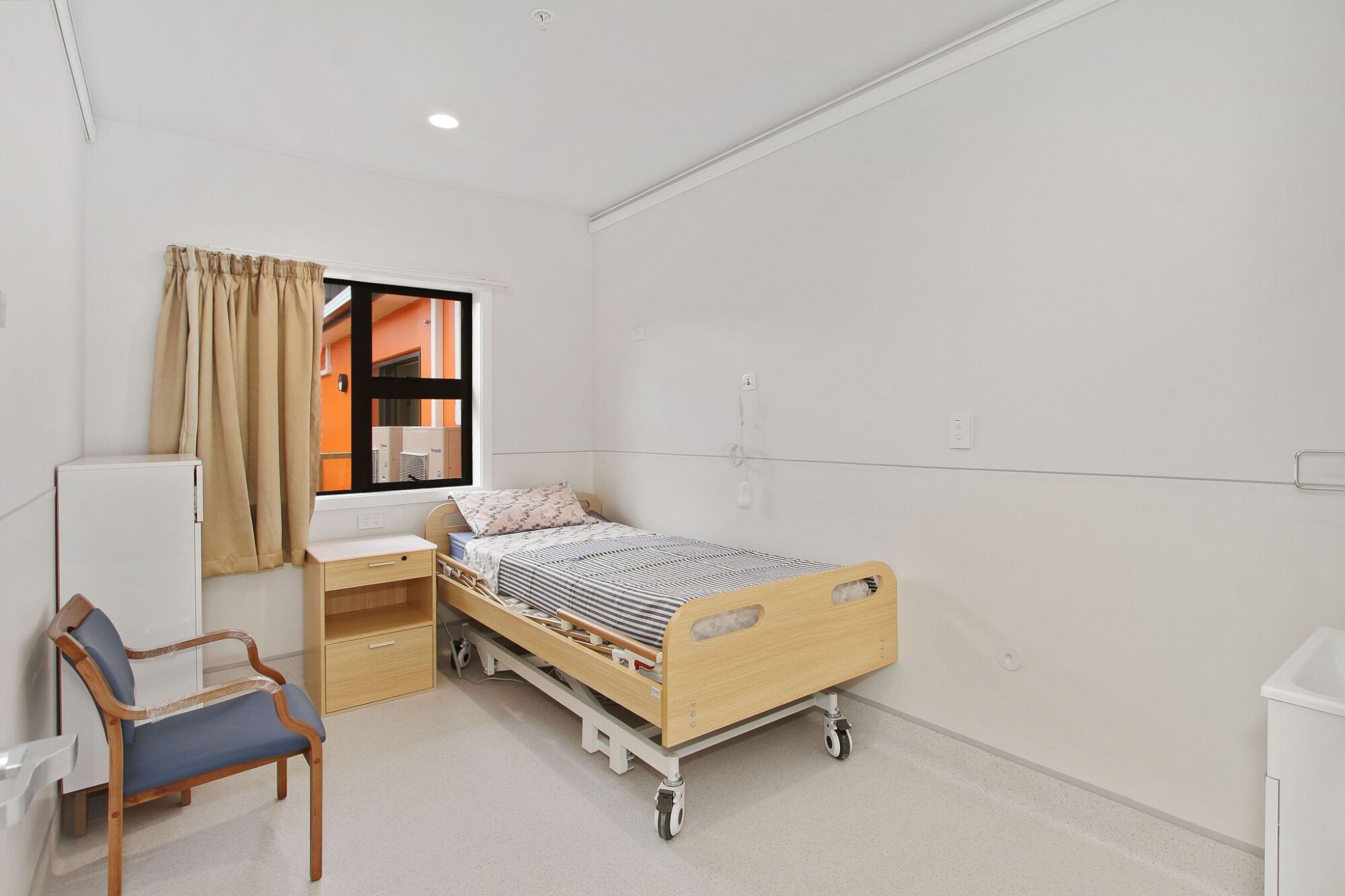 A nurse warmly holding hands with an elderly resident