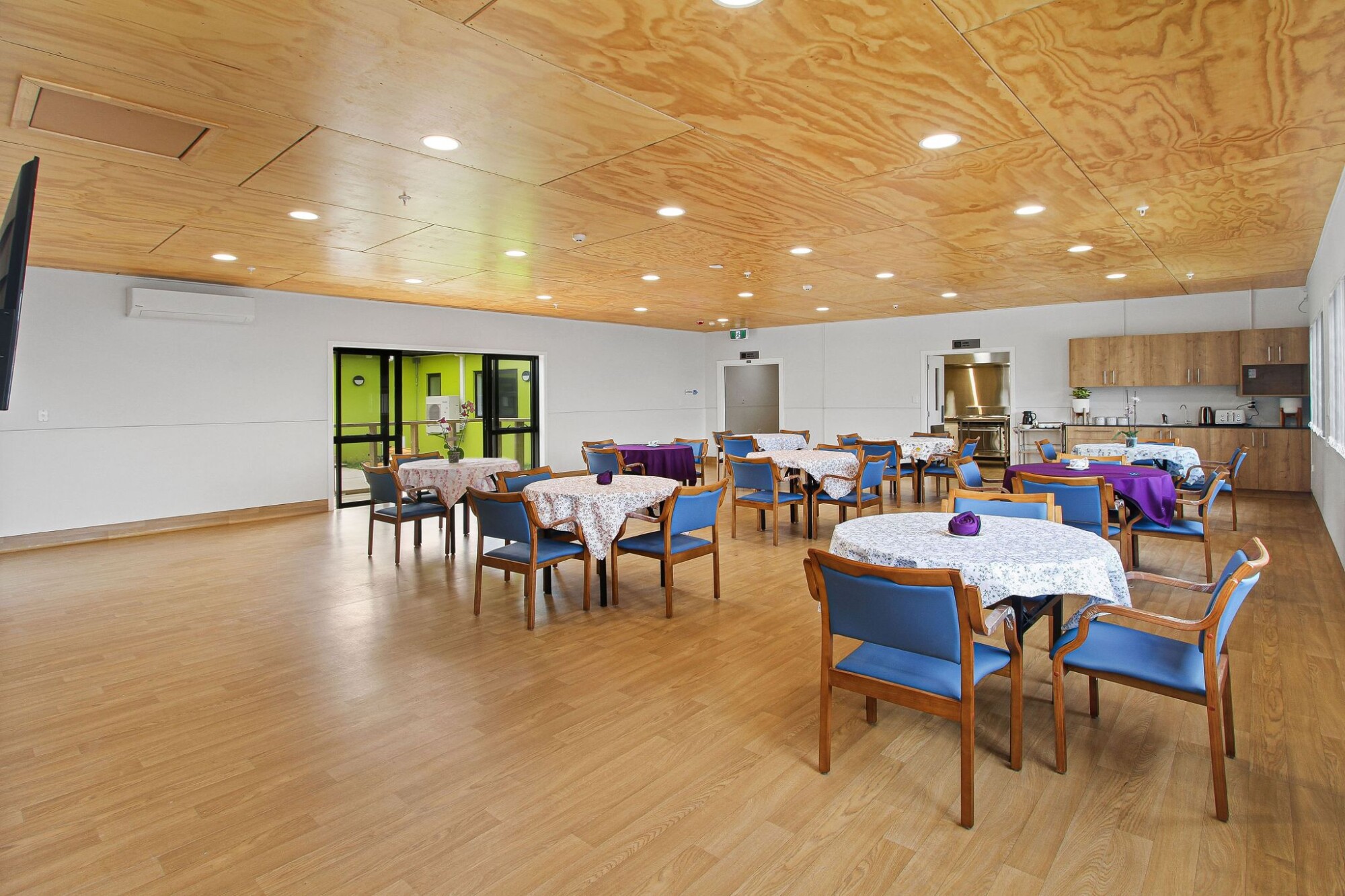 Bright dining area with set tables and flowers
