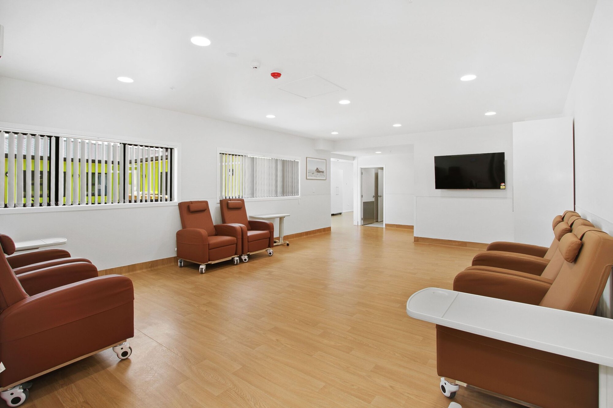 Bright shared lounge with sofas and a bookshelf